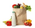 Paper bag with groceries on white Royalty Free Stock Photo