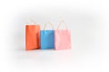 Paper bag in mix color, orange, blue and pink on white background. Shopping concept Royalty Free Stock Photo