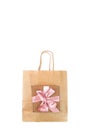Paper bag for shopping and gift box tied with a satin pink ribbon Royalty Free Stock Photo