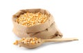Paper bag and spoon with raw corn kernels Royalty Free Stock Photo