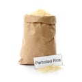 Paper bag with uncooked parboiled rice and card Royalty Free Stock Photo