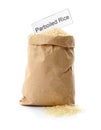 Paper bag with uncooked parboiled rice and card Royalty Free Stock Photo