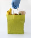 Paper bag wearing blue glove. delivery food during the coronavirus COVID-19 quarantine period