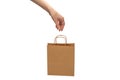 Paper bag in woman hands isolated on white background Royalty Free Stock Photo