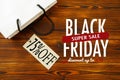 Paper bag on wooden  background with sale tag .  Black friday sale Royalty Free Stock Photo