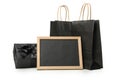 Paper bags, chalkboard and gift box isolated on white background Royalty Free Stock Photo