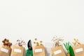 Paper bags with different kinds of seeds and gardening supplies on a white background. Gardeners store banner template