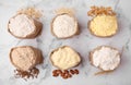 Paper bags with different types of flour and ingredients on white marble table, flat lay Royalty Free Stock Photo