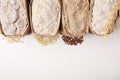 Paper bags with different types of flour on white background, top view. Space for text Royalty Free Stock Photo