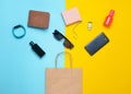 Paper bags and many purchases of gadgets and accessories on a colored background. Royalty Free Stock Photo