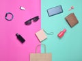 Paper bags and many purchases of gadgets and accessories on a colored background.