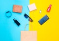 Paper bags and many purchases of gadgets and accessories on a colored background: sunglasses, smartphone, smart bracelet