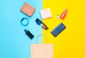 Paper bags and many purchases of gadgets and accessories on a colored background: sunglasses, smartphone, smart bracelet, powel