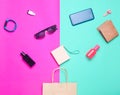 Paper bags and many purchases of gadgets and accessories on a colored background: sunglasses, smartphone, smart bracelet, powel