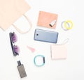 Paper bags and many purchases of gadgets and accessories on a white background: sunglasses, smartphone, smart bracelet, powel bank