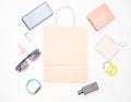 Paper bags and many purchases of gadgets and accessories on a white background: sunglasses, smartphone, smart bracelet, powel bank