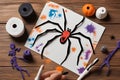 Paper, bandage, plasticine with paints on a wooden table. Halloween greeting card spider and cobweb, ghost skeletons. Crafts for Royalty Free Stock Photo