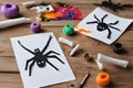 Paper, bandage, plasticine with paints on a wooden table. Halloween greeting card spider and cobweb, ghost skeletons. Crafts for Royalty Free Stock Photo