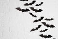 Paper bats on brick wall with space for text Royalty Free Stock Photo