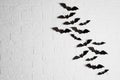 Paper bats on brick wall with space for text Royalty Free Stock Photo
