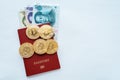 Paper bills China in a red passport white background with the Chinese currency yuan, gold coins bitcoin. Royalty Free Stock Photo