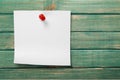 Pinned blank paper note on wooden background Royalty Free Stock Photo