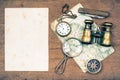 Paper blank, vintage binoculars, compass, old map, magnifying glass, pocket watches, knife on wooden background Royalty Free Stock Photo