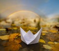 Paper boat on an autumn river