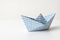 A paper boat with a binary code on a clean background. Space for text. Royalty Free Stock Photo