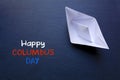 Paper boat on a blackboard and text Happy Columbus Day