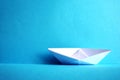 Paper boat in the blue paper sea