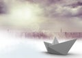 Paper boat in cloudy city