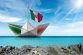 Paper boat with Italian flag in a turquoise sea - Photography Royalty Free Stock Photo