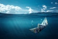 A paper boat made of money sinks into the sea under water. Financial crisis concept, debts, paying bills, mortgage, bankruptcy Royalty Free Stock Photo