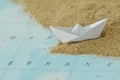 Paper boat on a map with sand - Immigration concept Royalty Free Stock Photo