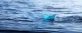 .Paper boat - Sail away, blue small origami boat on the water, panorama of the sea and a toy boat on the waves Royalty Free Stock Photo