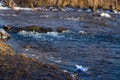 A paper boat on a turbulent stream of water struggles with the flow. Small paper boat is flowing along river Royalty Free Stock Photo