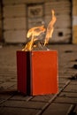 Paper book burns to ashes, on concrete tiles, manuscript burns, open book with fire Royalty Free Stock Photo