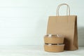 Paper bowls and paper bag on white wooden table Royalty Free Stock Photo