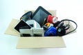 Paper box with the damaged or old used electronics gadgets for daily use on white background