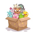 Paper box full of round stuffed animal toys.