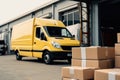 Paper boxes lies on pallets unloaded from a cargo minibus in front of a warehouse