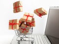 Paper boxes in a shopping cart on a laptop keyboard. Ideas about e-commerce, a transaction of buying or selling goods or Royalty Free Stock Photo