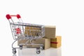 Paper boxes in a trolley on white background. Ideas online shopping is a form of electronic commerce that allows consumers to