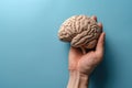 A paper brain in the palm of a person\'s hand