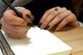 paper in business woman female hand writing notes on a table black manicure and blank letter Royalty Free Stock Photo