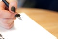 paper in business woman female hand writing notes on a table black manicure and blank letter Royalty Free Stock Photo