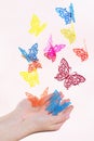 Paper butterflies fly out of girls hands