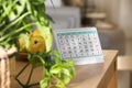 Paper calendar and plate with pears on table indoors