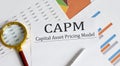 Paper with CAPM Capital asset pricing model on a table Royalty Free Stock Photo